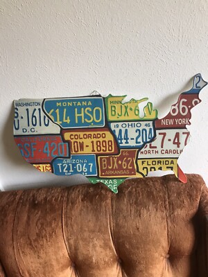 13 vintage State licance plates on a cut out metal USA map