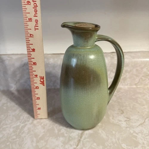 A vintage Frankoma Lazy Bones Prairie Green ceramic pitcher with cork.