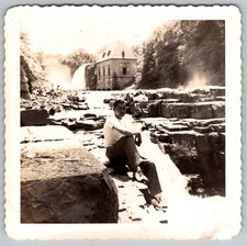 Vtg B&W Snapshot Man Sitting On Rocks By Waterfall And Stone Building 1947
