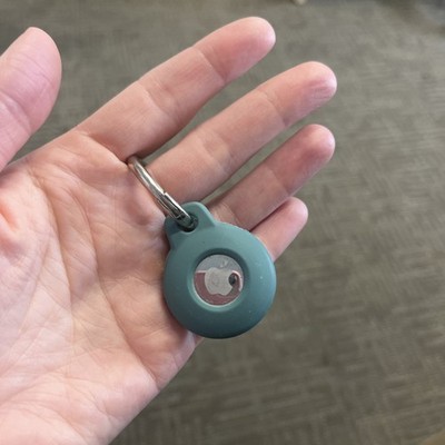 Silver Apple AirTag In A Blue Case