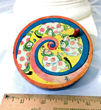 vintage tin noise maker w/ wooden handle/clowns -likely by T. Cohn - good workin