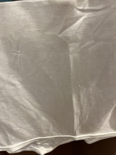 White vintage Frank Shorter sports wear cycling jersey with visible stitching and minor yellowed fabric on a gray background.