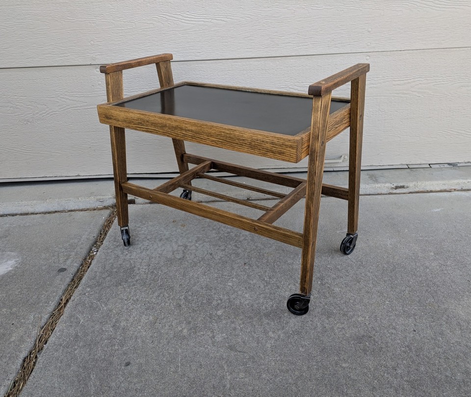 Atomic-era solid oak rolling bar cart — the 'Atomic' styling on real wood makes this a rare, museum-worthy find at a reasonable price.