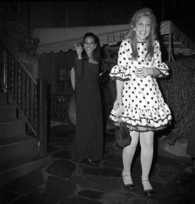 Jane Holzer wearing a polka dot ruffled dress at a dinner at Cafe - Old Photo