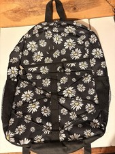 Black backpack featuring a white daisy floral pattern with yellow centers.