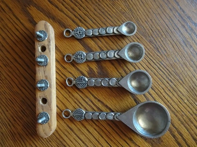 Fancy matal measuring spoon on a wooden rack 1/4t, 1/2t.1t.and T