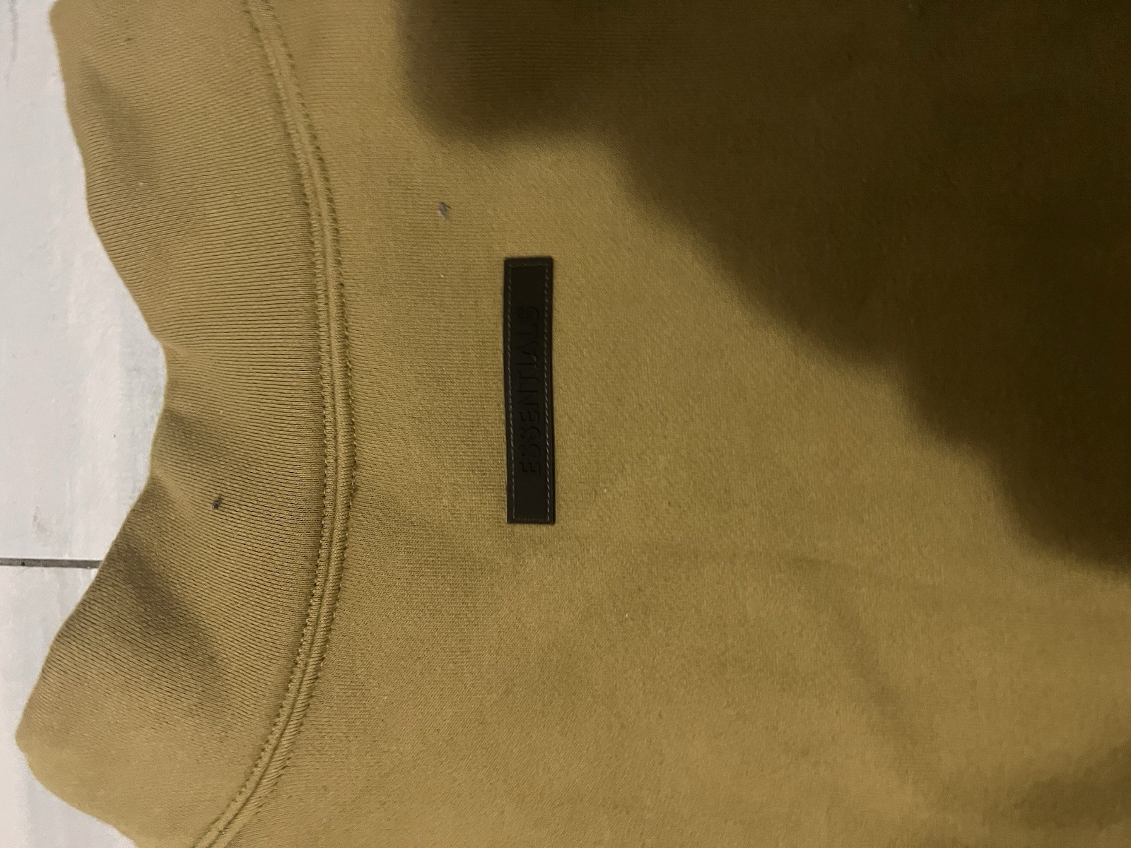 This is a Fear of God Essentials mock neck sweatshirt in an Amber Color. thumbnail 3