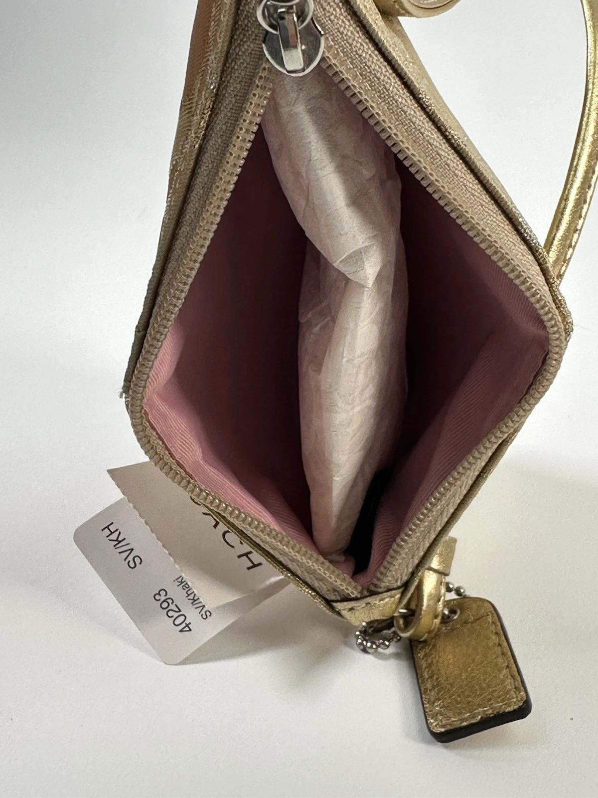 Mini pochette Coach da polso oro metallizzato e argento con logo monogramma e cerniera