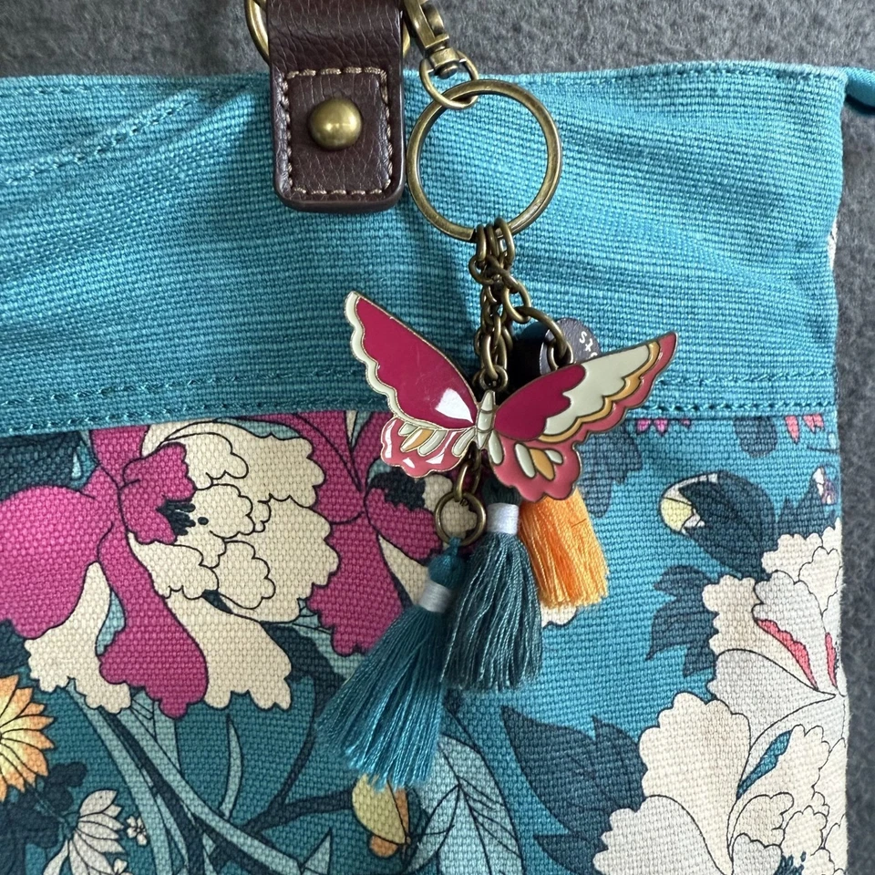 Bolso de Mano Hobo Floral de Lona Sakroots Para Mujer Azul Teal Mariposa Dije Borlas Foto 2 de 4