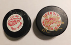 2 signed red wings hockey pucks Osgood and other