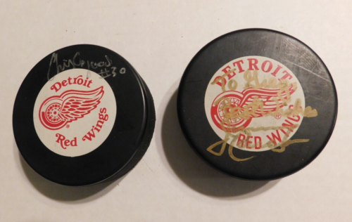 2 signed red wings hockey pucks Osgood and other