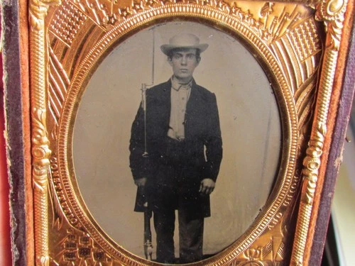 Civil War soldier with rifle at his side tintype photo behind a military mat