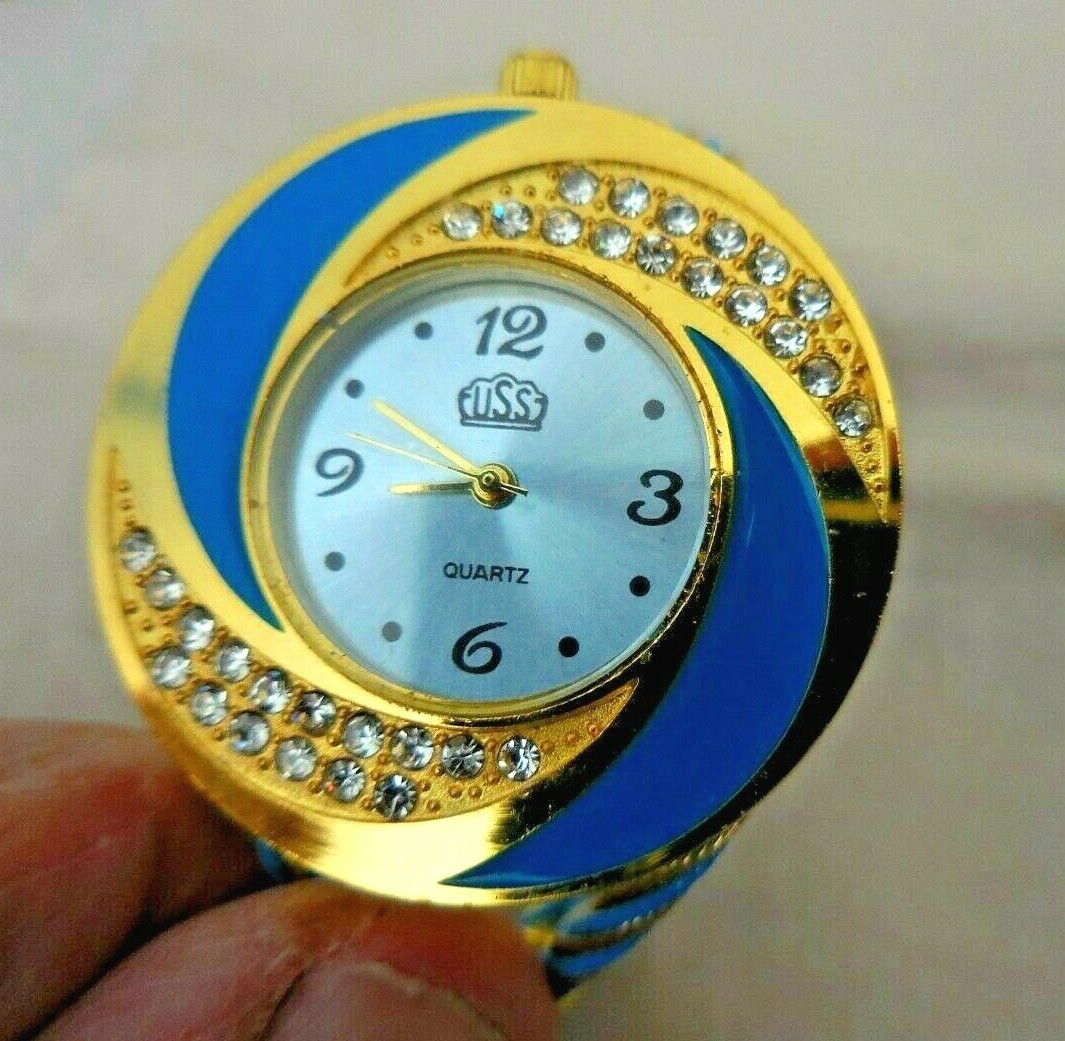 Montre pince Hélice USS-1409 dorée et bleue sertie de cristaux Swarovski pour femme