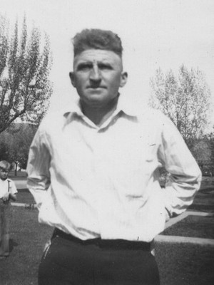 1950s Handsome Man White Shirt Serious Expression Children in Background