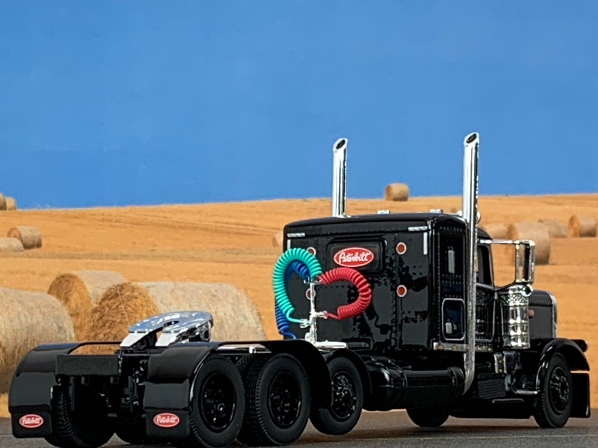 1/64 DCP BLACK PETERBILT 389 TRI AXLE W/ 36
