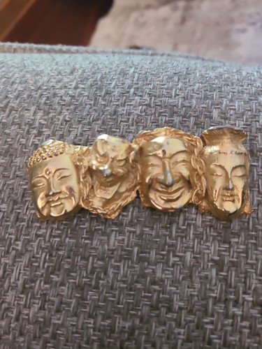 Brooch goldtone Aisian theatrical faces. Unmarked. Heavy