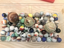 over 100 marbles of various sizes and makers