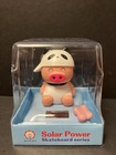 Solar Powered Dancing Bobblehead Toy-  Pig on Pillow in Cow Hat
