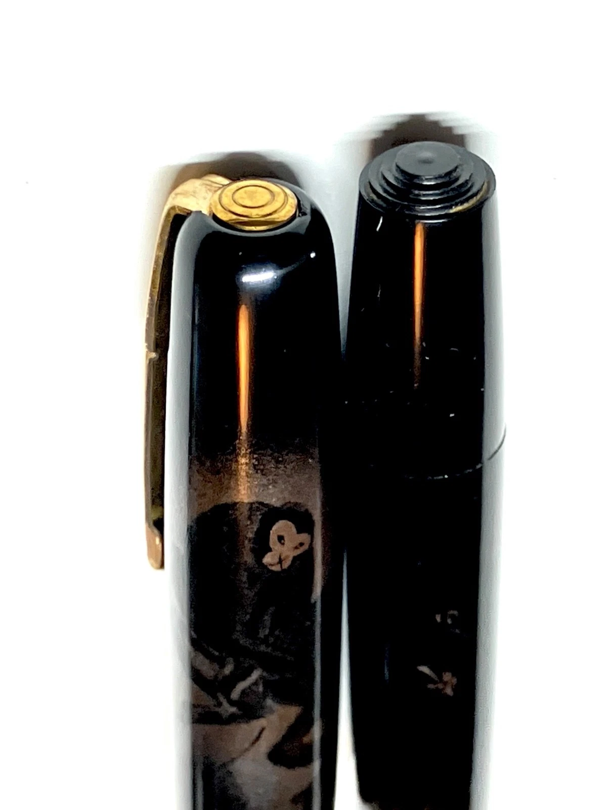 Black vintage fountain pen with gold accents and “HARUYAMA made urushi maki-e” text on white body, on right side.