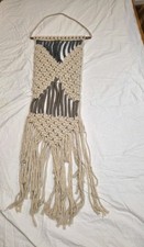 macrame wall hanging featuring a beige and gray geometric design with fringed...