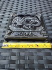 Silver metal Cruver Chicago Celluloid Dragon trinket box with ornate lid, shown on a dark textured surface.