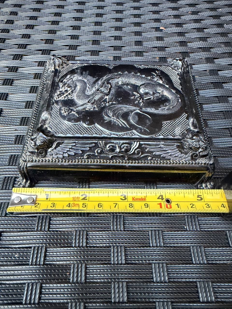 Silver metal Cruver Chicago Celluloid Dragon trinket box with ornate lid, shown on a dark textured surface.