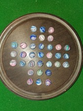 Solitary game with antique Pee wee Onion skin glass marbles.