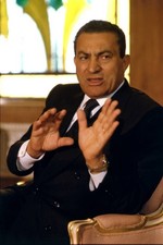 Egyptian President Hosni Mubarak sitting on a chair while talking - Old Photo