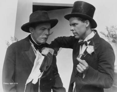 Two actors, one holding other by scarf, while also holding a lock  Old Photo