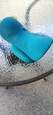 Ergonomic neck and shoulder relaxer is made of a textured blue foam material.