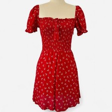 Cherry red mini dress with a ditsy floral scatter and softly puffed sleeves.