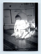 Old Vintage Photo BABY BASKING IN SUNLIGHT BY KITCHEN STOVE ANTIQUE SNAPSHOT