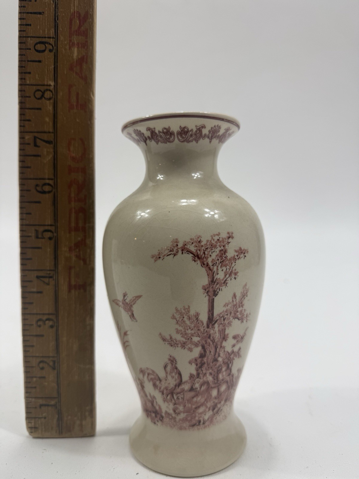 White porcelain vase with pink toile de Jouy pastoral scene.