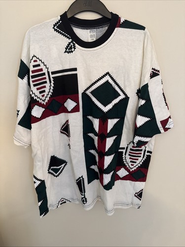White vintage T-shirt with multicolor geometric and abstract patterns in red, green, black, and red, made in USA.