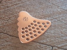 Handmade and playable copper guitar pick - shark tooth shape and holes to