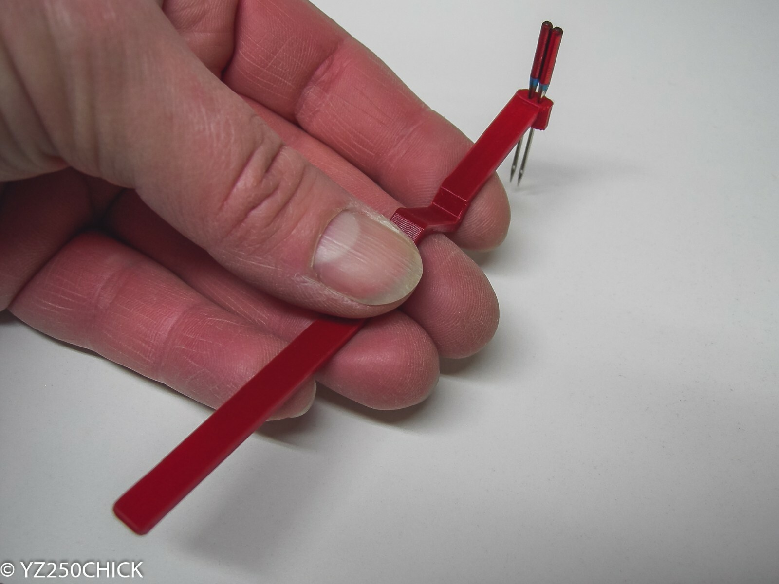 serger needle inserter installer holds two needles Sewing Machine