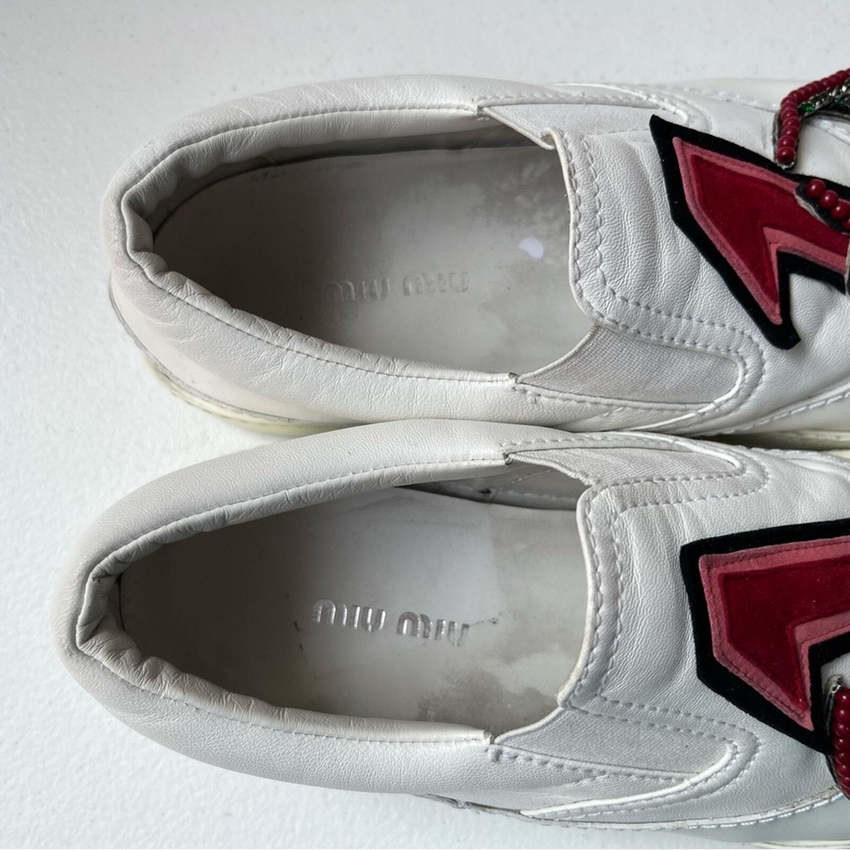 Miu Miu Embellished Patch Logo Slip-On Leather Sneakers Miu Miu Embellished Patch Logo Slip-On Leather Sneakers