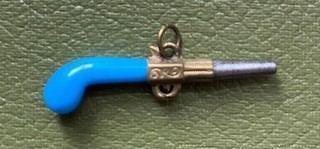 Pocket watch winder key turquoise pistol in good condition.