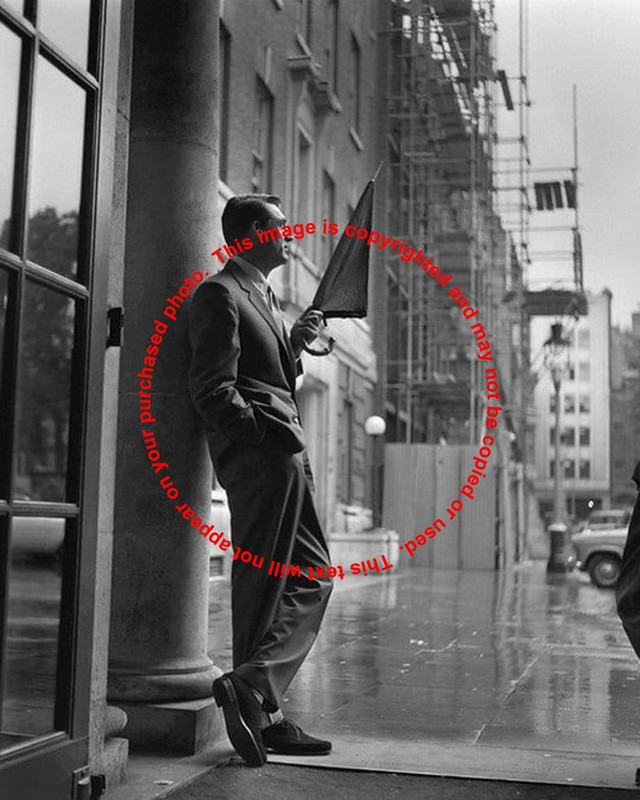 Cary Grant Holding an Umbrella