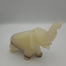 Onyx elephant figurine, 5 3/4 L, 4" T, trunk up, cream color with brown band