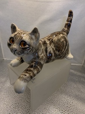 Winstanley Tabby Cat With Glass Eyes. The Front Paw Hangs Over The Edge Of Shelf