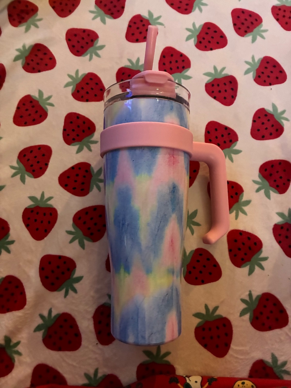 Pink, yellow and blue water bottle with pink handle.  Rubber pink straw included