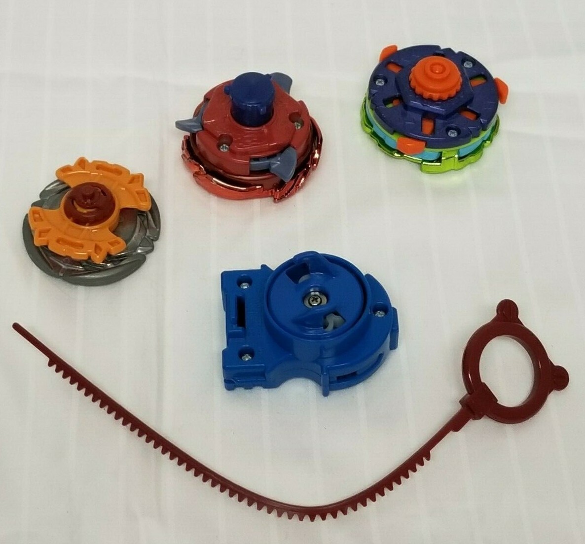 BeyBlades Lot - 3 Beyblades, 1 ripchord launcher with pull - Pre-owned ...
