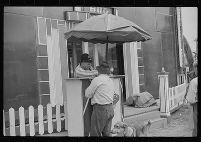 Photo:1930s Carnival Booth Man in Hat Dog Umbrella Fairground