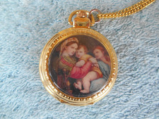 GOLD TONE 1-1/2" QUARTZ POCKET WATCH NECKLACE WITH ART. NEEDS NEW BATTERY