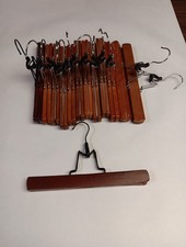 set of 12 wooden clamp pants or skirt hangers with metal clips and a swivel hook