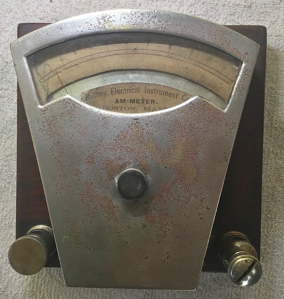 An 1893 Whitney vertical ammeter in a heavy brass case — pre-dates standardized electrical systems and looks like a prop from a Jules Verne novel.