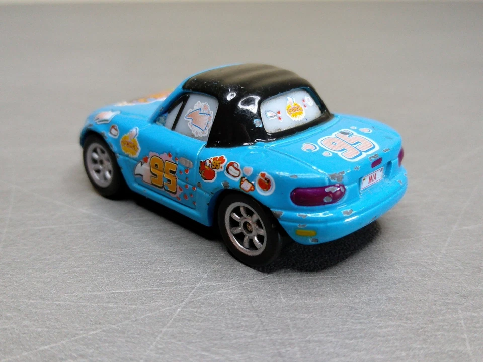 Disney Cars Mia Dinoco Fan Flash McQueen Coche De Metal 1/55 TBE Azul Raro - Imagen 3 de 4
