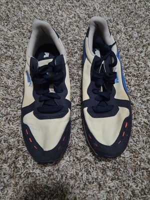 Puma Cabana Run sneakers featuring a white, navy blue, and orange colorway...