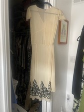 Beautiful 100 silk dress, sheer with black beads on the hemline neck line